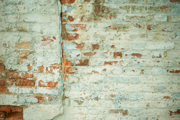 istock Wall with painted brick and peeled paint.Texture. Abandonment 1265091144