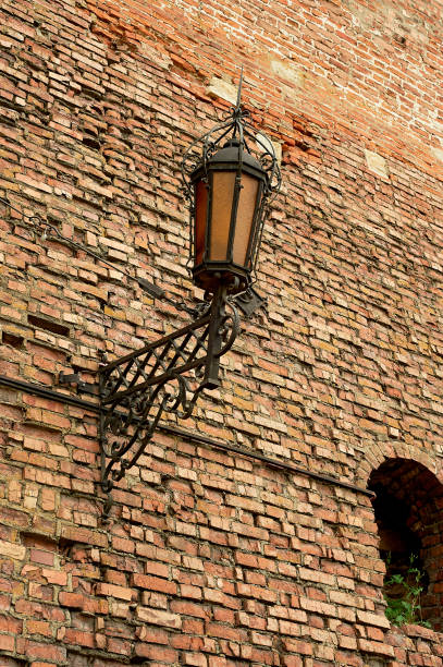 istock An ancient forged lantern on a red brick wall. Ancient fortress, history 1265091199