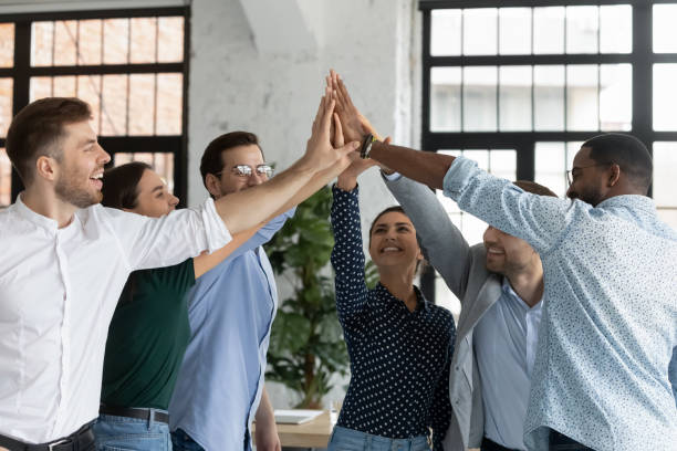 istock Overjoyed successful diverse employees giving high five at meeting 1265092921