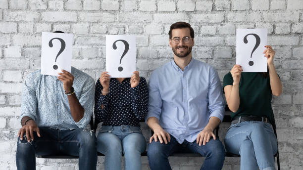 istock Confident smiling businessman sitting in row with unknown people 1265092935