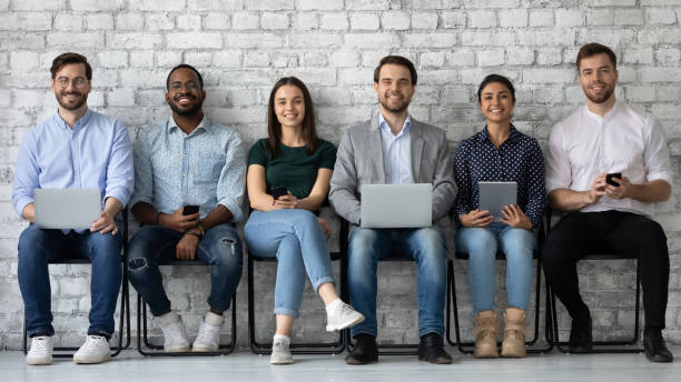 istock Portrait smiling diverse candidates sitting on chairs in row 1265092941