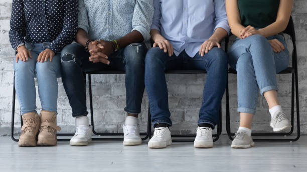 istock Close up diverse candidates sitting in row, waiting for job interview 1265092942