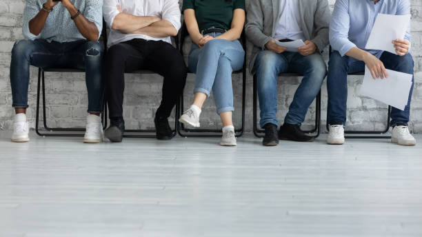 istock Cropped image legs of diverse candidates waiting for job interview 1265092954