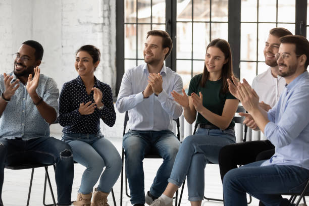 istock Smiling diverse employees applauding, clapping hands, cheering mentor coach 1265092976
