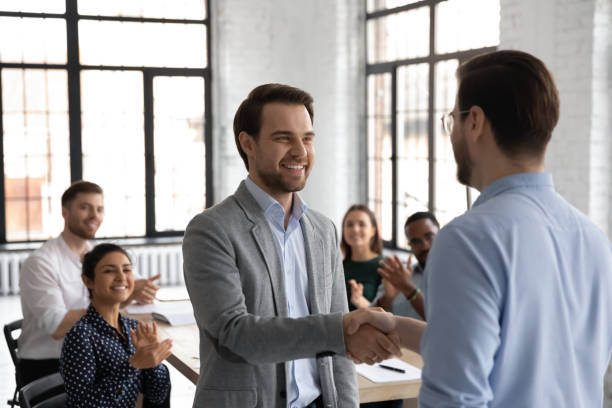 istock Close up leader thanking successful employee for good work, handshake 1265093346