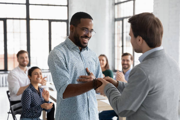 istock Close up executive shaking successful African American employee hand 1265093349