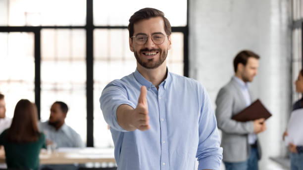 istock Head shot portrait smiling businessman extending hand for handshake 1265093373