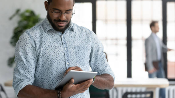 istock Close up focused African American businessman using computer tablet 1265093396
