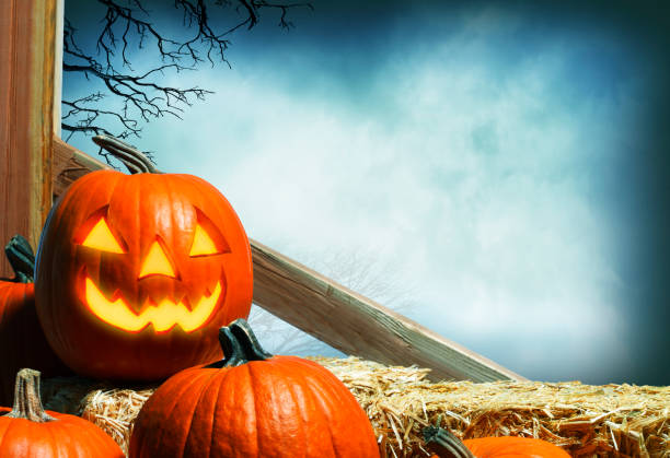 istock Jack O'Lantern Sitting On Hay Bales 1265094215