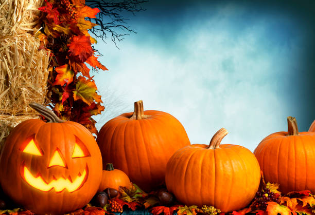 istock Jack O'Lantern And Pumpkins Sitting Next To Hay Bales 1265095172