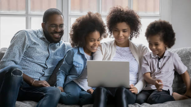 istock Happy biracial family with kids using laptop 1265096820