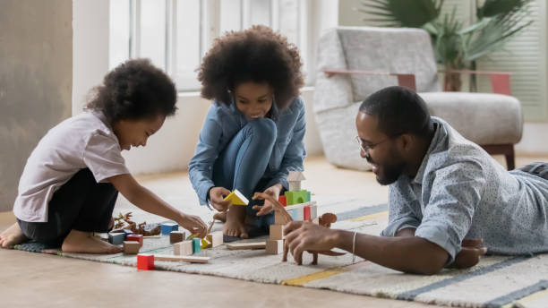 istock Playful biracial dad play with two children at home 1265096836