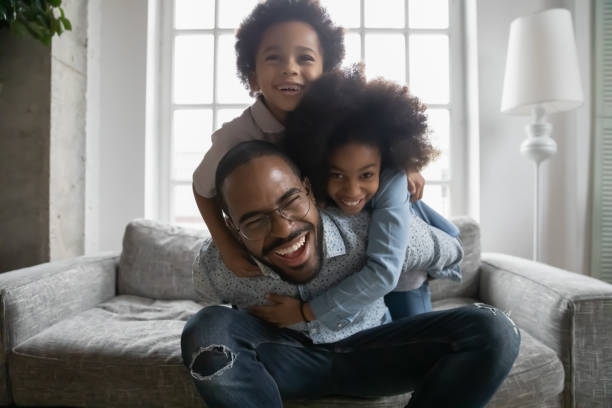 istock Playful african American dad play with small kids 1265096844