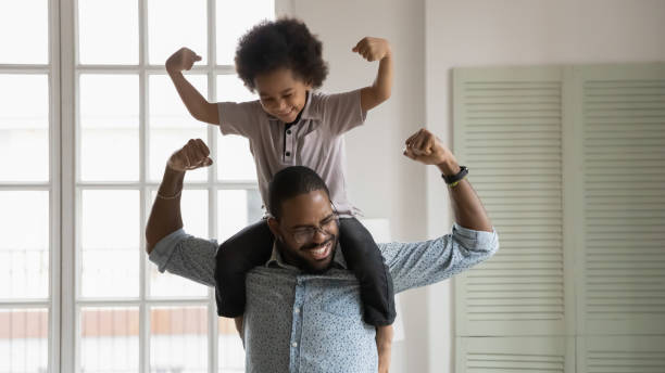 istock Happy biracial dad play with little son at home 1265096846