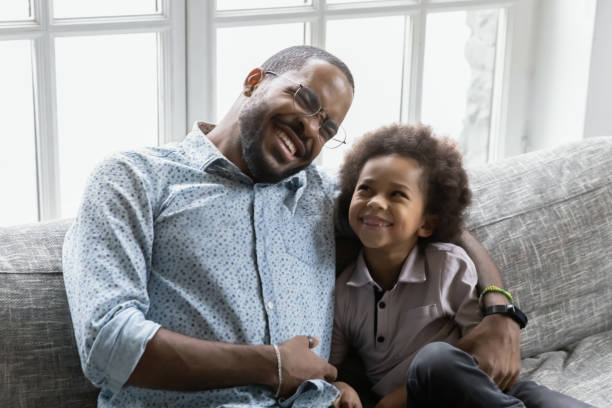istock Happy biracial dad and son cuddle on couch 1265096867