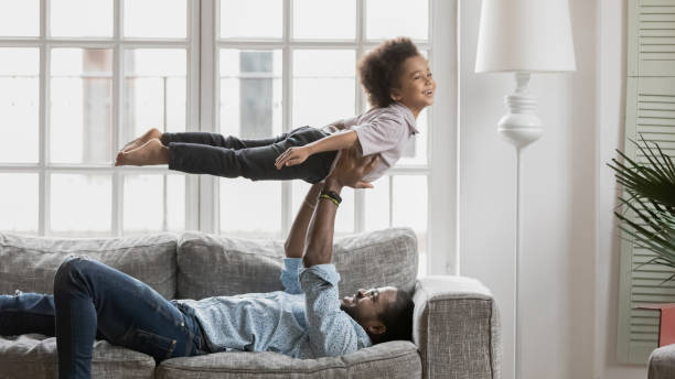 istock Excited biracial dad and little son playing at home 1265096875