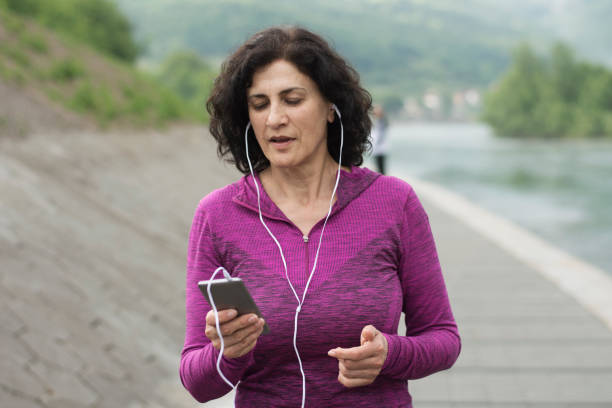 istock Mature female jogger is on a video call 1265098528