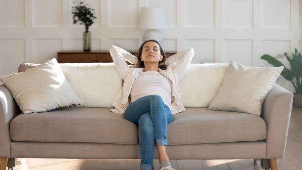 istock Relaxed young 30s woman sleeping on comfortable couch. 1265099318