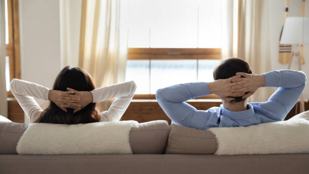istock Young happy married couple relaxing on sofa. 1265099365