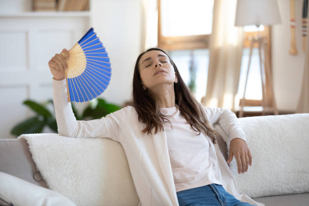 istock Unhappy young mixed race girl using paper fan. 1265099407