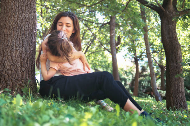istock Happy mother smiling and playing with her daughter 1265100364