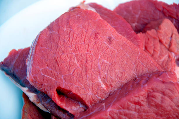 close-up of two filet mignon with rosemary and garlic