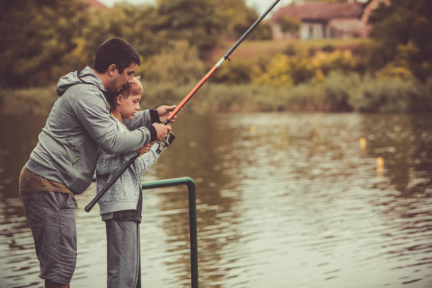 istock Three quarter length shot of man helping kid to fish 1265104023
