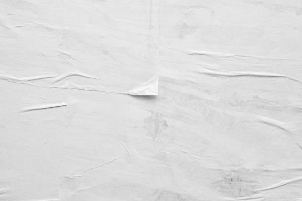 istock Blank white crumpled and creased paper poster texture background 1265104130
