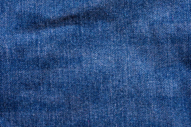 istock Denim blue jeans texture close up background top view 1265104896