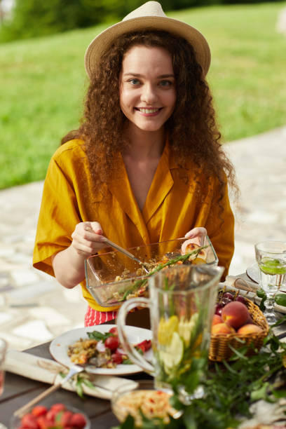 istock Carefree Young Woman Enjoying Dinner Outdoors in Summer 1265109385