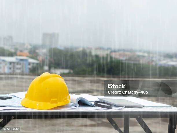 Engineering Outside Construction Raining Stock Photo - Download Image Now - Rain, Construction Industry, Occupation