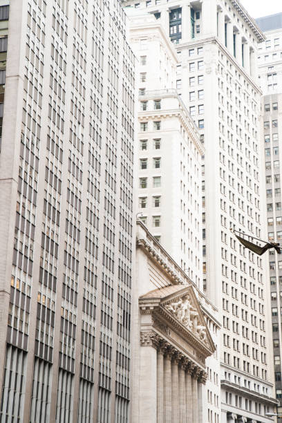 Wall Street sign post in front of Stock Exchange building in New York