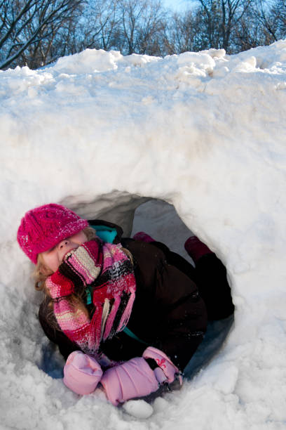 istock Girl tunneling throught a snowbank 1265114211