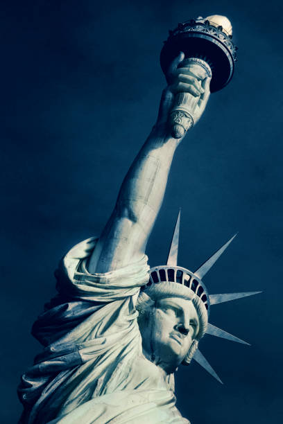 Statue of Liberty monument against a blue sky, New York City, New York, United States, USA
