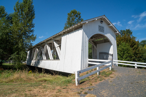 The Weddle Bridge, a white covered bridge near Sweet Home, Oregon, spans Ames Creek