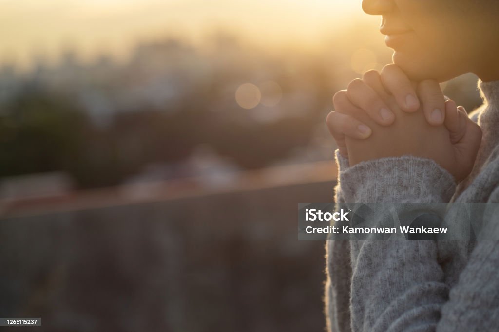 Women raise their hands to ask for blessing from God. Praying Stock Photo