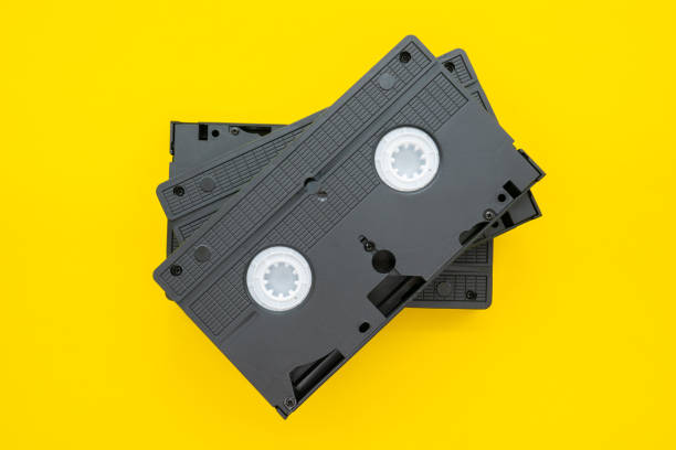 istock Old VHS video cassette tape on yellow background 1265115901