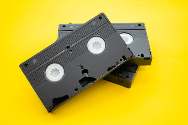 istock Old VHS video cassette tape on yellow background 1265115977