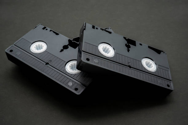 istock Old VHS video cassette tape on wooden board 1265116040