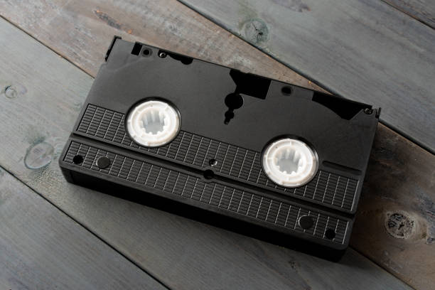 istock Old VHS video cassette tape on wooden board 1265116049