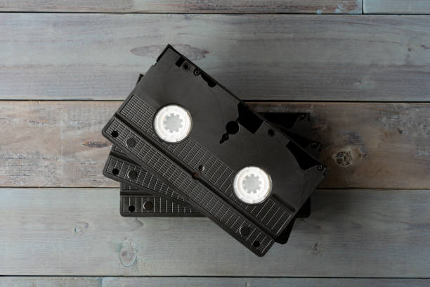 istock Old VHS video cassette tape on wooden board 1265116100