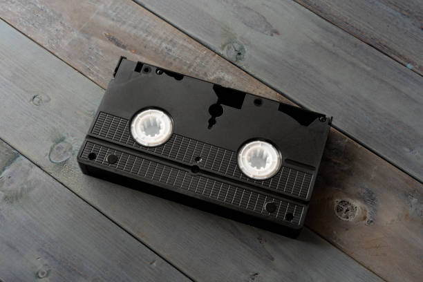 istock Old VHS video cassette tape on wooden board 1265116736