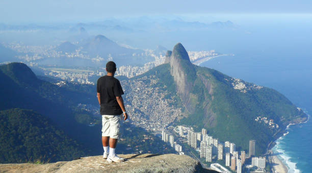man admiring the look of the top of the Gavea stone ( pedra da gavea ) in Rio de Janeiro stock photo