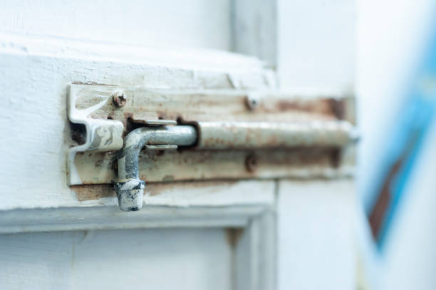 istock old metal latch on white door 1265127103