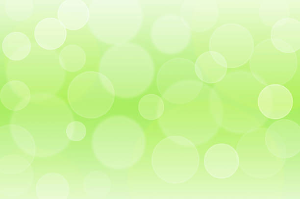 istock Defocused illuminated blurred blinking lights. Sparkling bright bokeh on soft pastel green background 1265129196