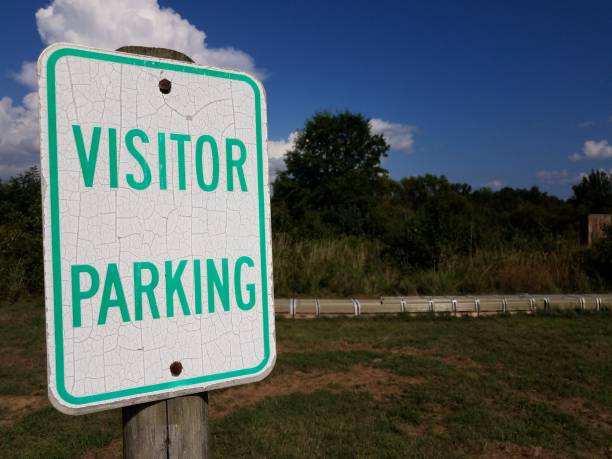 istock weathered white and green visitor parking sign 1265132231