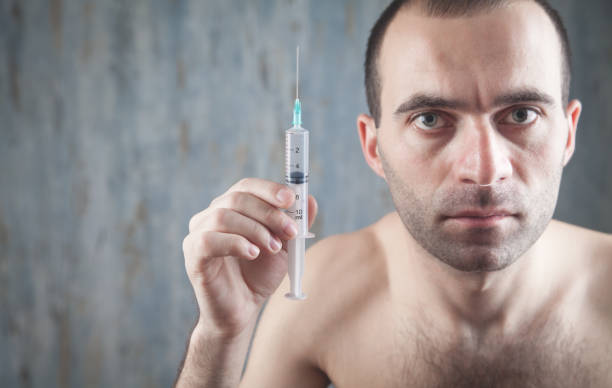istock Man showing syringe. Injection. Medical 1265135457