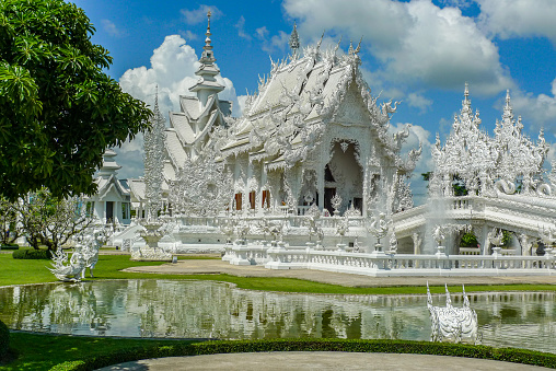 Wat Rong Khun (White Temple), Chiang Rai, Thailand. Main hall viewed across pond.