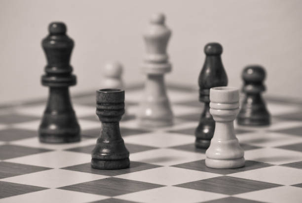 istock Chess board with black and white figures, two rooks in focus 1265140358