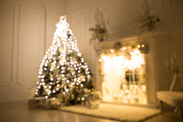 istock Blurred background. Three elegant Christmas trees in a bright room. New Year's and Christmas 1265143249
